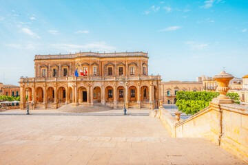 view in Noto, with the Basilica Minore di San Nicolo and Palazzo Ducezio, Sicily, Italy. Palazzo...