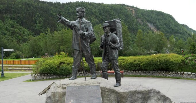Skagway Centennial Statue is located in Skagway Centennial Park, Alaska.Depicting a Tlingit packer showing the way to a prospector.