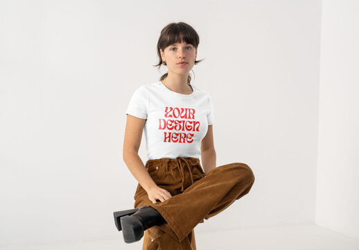 Mockup Of Woman Wearing Customizable T-Shirt, Sat On Stool