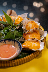 Nha Trang, Vietnam. Oyster grilled in cheese being served at local restaurant