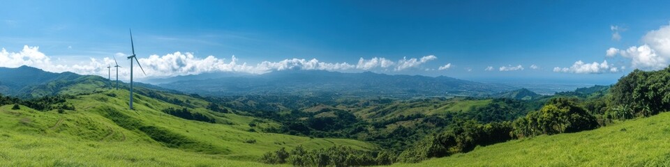 Panorama of wind turbines in green hills under a blue sky nature landscape wide-angle view