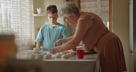 A heartwarming scene of a grandmother and grandson baking together, sharing family traditions and creating lasting memories.