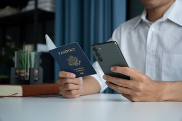 Man holding passport in hand and booking ticket on phone