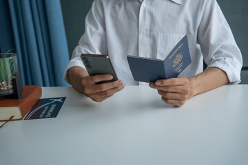 Man holding passport in hand and booking ticket on phone