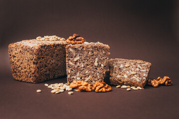 Loaf of homemade bread with sunflower seeds and nuts close-up, natural light with copy space