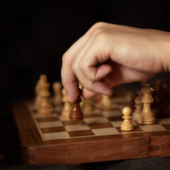 Hand of man moving chess figure in competition success play strategy