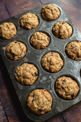 High angle close up of banana chocolate chip muffins in tin.