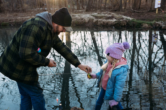 Dad helping daughter bait fishing pole at Montauk State Park