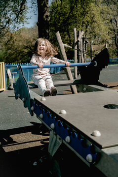 Smiling little girl at playground, outdoor activity
