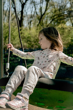 Toddler girl on swing, playground. Education, activity outdoor