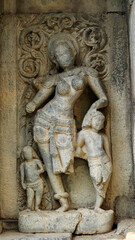 Broken carved sculpture of a woman with children at Shri Pachchala Someshwara Temple, Panagallu, Nalgonda, Telangana, India.