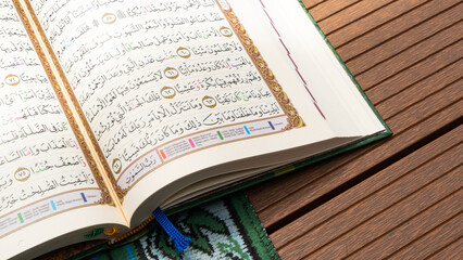 Bandung, Indonesia - 02.11.2025:  Photo of opened Holy Quran with Arabic calligraphy with natural...