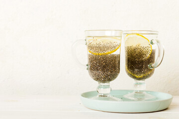 Healthy breakfast or morning with chia seeds and lemon on table background, vegetarian food, diet and health concept. Chia pudding with lemon
