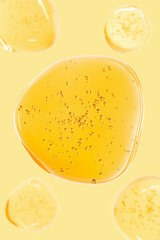 3D transparent golden gel texture with air bubbles on yellow background. Perfect for skin care, advertisement cosmetics. Cooking oil. Motor oil. Macro shot.
