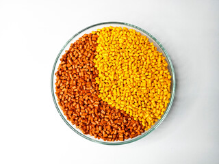 Yellow, orange polymer granules, masterbatch granules, cold cutting material type, isolated on white background for product catalog design of plastic manufacturing industry company profile	