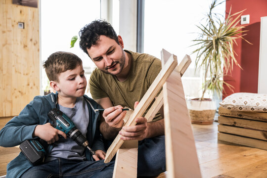 Father and son enjoying quality time together working on a DIY project at home