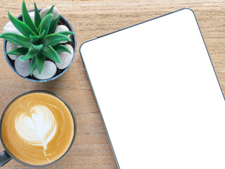 Template, mockup of digital tablet with a blank white screen and coffee cup over a wooden background. Concept online shopping, blog, logo, product, and social media. Top view with copy space. .