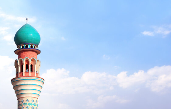 Horizontal banner with minaret of Friday Mosque against a blue sky backdrop with white clouds, Ardabil, Iran. Topic of vacation, travel, trip abroad on vacation, cruises and tours. Copy space for text