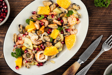 Plate of delicious fruit salad with seafood.