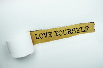 Love Yourself message written on craft paper with torn paper background