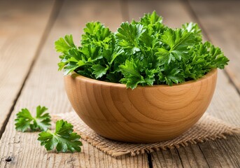 Fototapeta premium Fresh parsley in a wooden bowl on rustic wooden table with burlap cloth