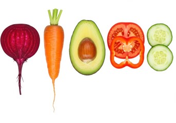 Arrangement of fresh beetroot, carrot, avocado, tomato, bell pepper, and cucumber slices on a white background