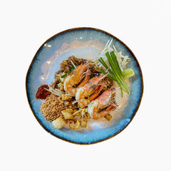 isolated top view of Prawn Pad Thai dish on white background