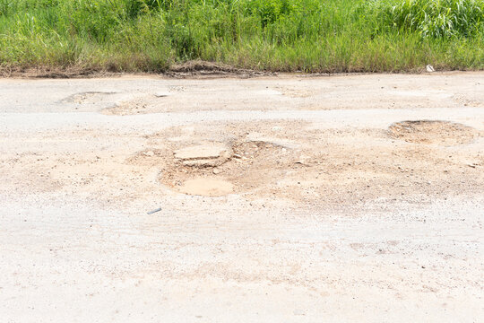 Asphalt road surface damage at local. Occure pothole, gravel and asphalt to broken crack. Dangerous for vehicles, transportation, traffic. Need repair, maintenance, renovate or reconstruction.