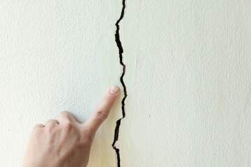 Large long crack or damage on concrete wall. Problem issue from low quality concrete, old,...