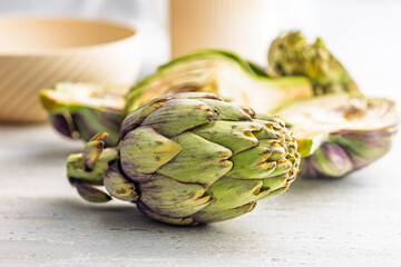 Ripe artichokes plant on kitchen table.