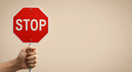 hand holding stop sign