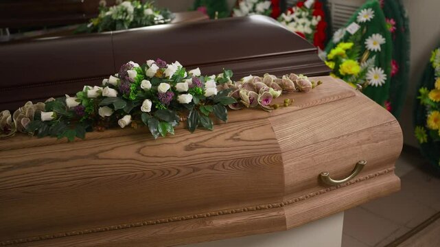 A coffin decorated with white flowers.