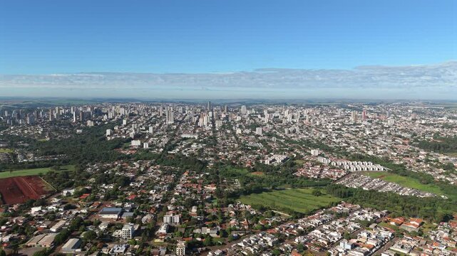 Panoramic aerial view of a large Cascavel cityscape stretching along an urbanistic area, Paraná, Brazil.