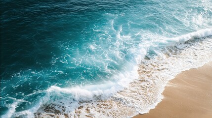 Stunning bird's-eye view showcasing the hypnotic meeting point of crystal-clear turquoise waves and warm beach sand