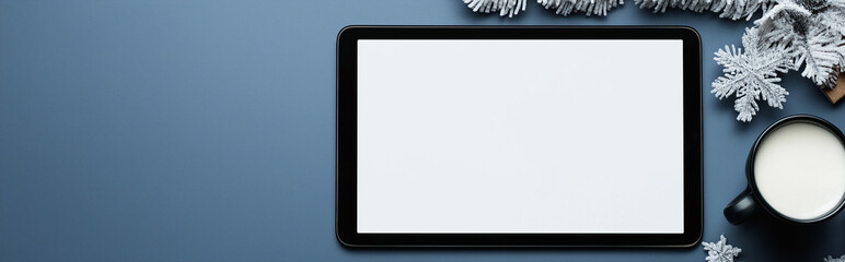 Obraz premium Festive christmas scene with a tablet mock up and a cup of warm milk and decorations