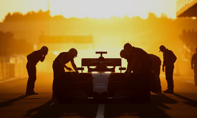 Backlit silhouette of racing car  crew preparing the car at dawn misty track Generative AI
