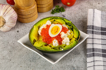 Avocado with red caviar and quil egg