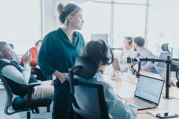 A diverse group of business people engaged in a meeting, brainstorming and discussing solutions in a contemporary office setting. The atmosphere is collaborative and focused on teamwork.