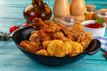 Golden crispy fried chicken mix - wings, drumsticks, nuggets and strips