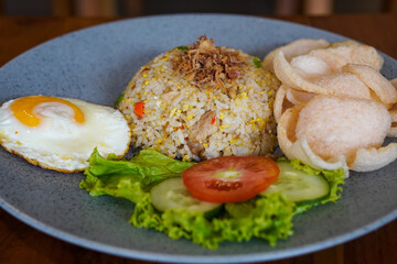 Indonesian fried rice, captured on May 6, 2025. A flavorful stir-fried rice dish with sweet soy sauce, garlic, chili, and traditional spices, served with egg and savory side dishes