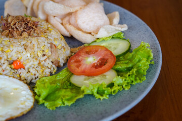 Indonesian fried rice, captured on May 6, 2025. A flavorful stir-fried rice dish with sweet soy sauce, garlic, chili, and traditional spices, served with egg and savory side dishes