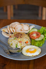 Indonesian fried rice, captured on May 6, 2025. A flavorful stir-fried rice dish with sweet soy sauce, garlic, chili, and traditional spices, served with egg and savory side dishes