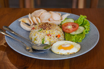 Indonesian fried rice, captured on May 6, 2025. A flavorful stir-fried rice dish with sweet soy sauce, garlic, chili, and traditional spices, served with egg and savory side dishes