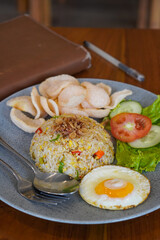 Indonesian fried rice, captured on May 6, 2025. A flavorful stir-fried rice dish with sweet soy sauce, garlic, chili, and traditional spices, served with egg and savory side dishes