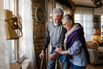 Upset elder wife comforting senior husband, talking to anxious man, giving support, empathy, love