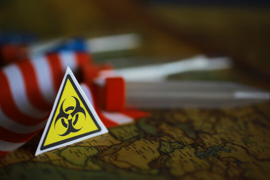 American flag and biohazard sign. The concept of American biolabs and research centers.