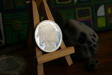 A silver coin on an easel depicting a North American Indian. Investment currency.