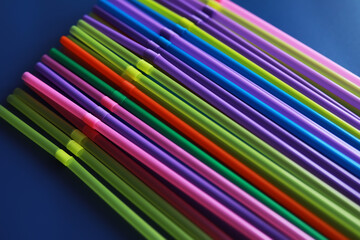 Colorful plastic drinking straws, close up as background. colored tubules for juice and cocktails...