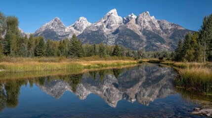 Stunning view of grand tetons mountain range with crystal-clear reflection in serene lake, wyoming