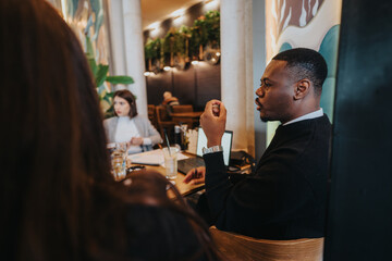 A group of diverse business professionals are engaged in a focused discussion in a modern office, highlighting teamwork and collaboration in a professional workspace.